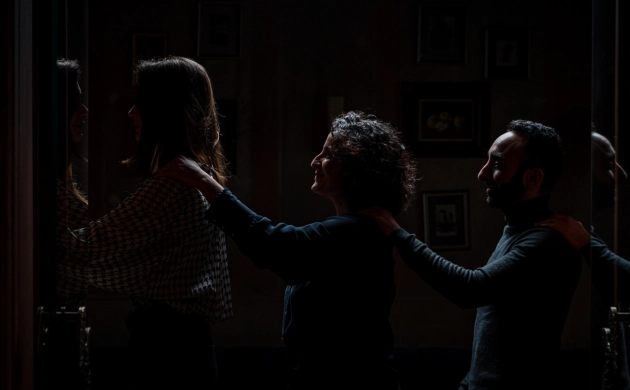 Guests entering the dark dining room, guided by touch and trust, for a sensory and immersive experience in Hong Kong