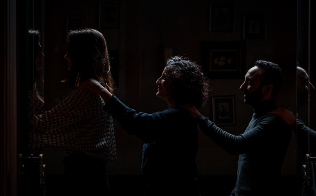Guests entering the dark dining room, guided by touch and trust, for a sensory and immersive experience in Hong Kong
